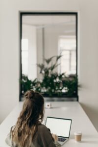 Job seeker preparing an electronic resume on a laptop before uploading it to an application portal